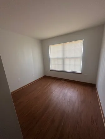 an empty room with wooden floor