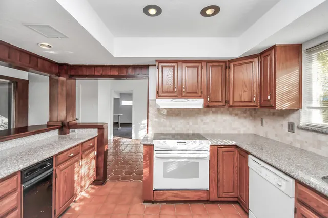 a kitchen with a sink stove and cabinets