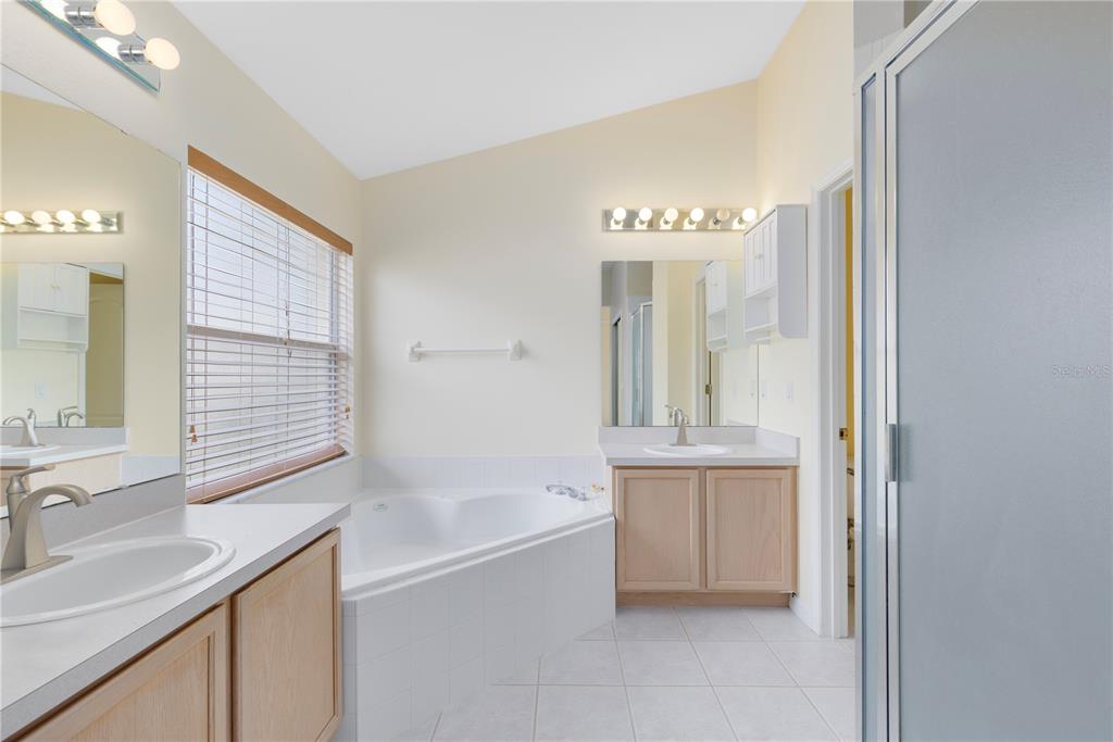 3640 Sickle Street Orlando, FL 32812 - Photo 11 of 21 a bathroom with a tub sink and mirror