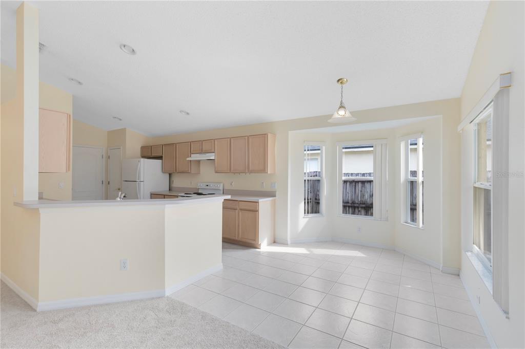 3640 Sickle Street Orlando, FL 32812 - Photo 4 of 21 a large white kitchen with granite countertop a sink