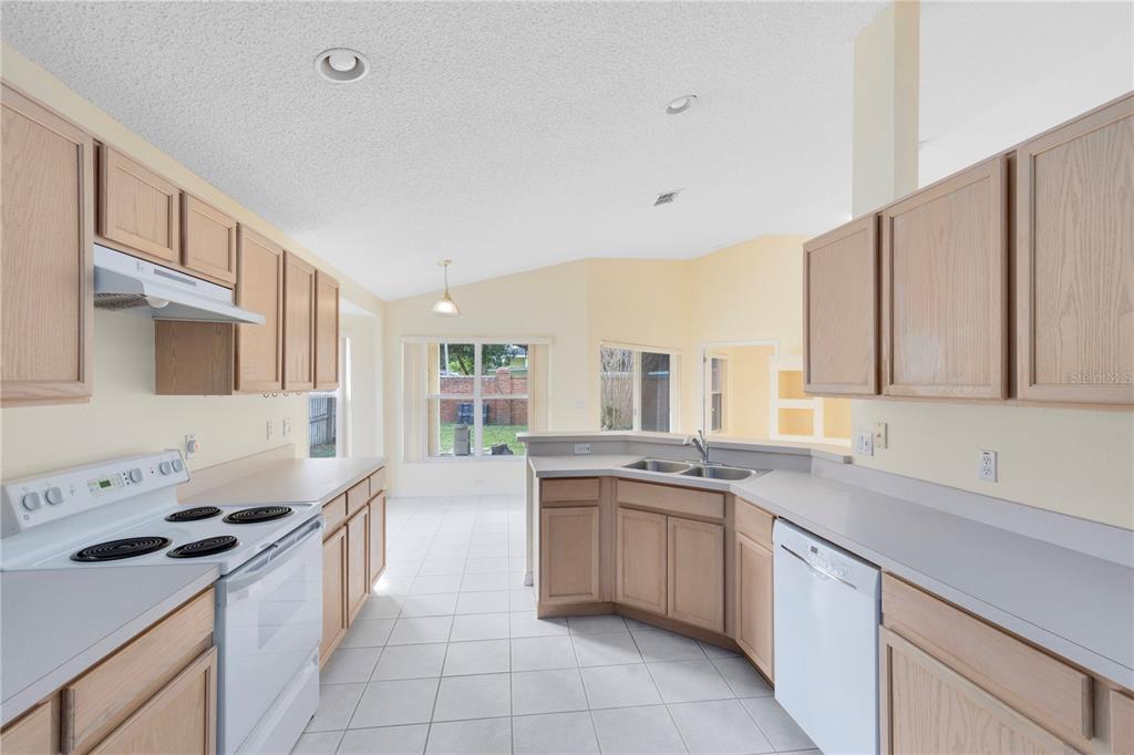 3640 Sickle Street Orlando, FL 32812 - Photo 7 of 21 a kitchen with a sink stove top oven and cabinets