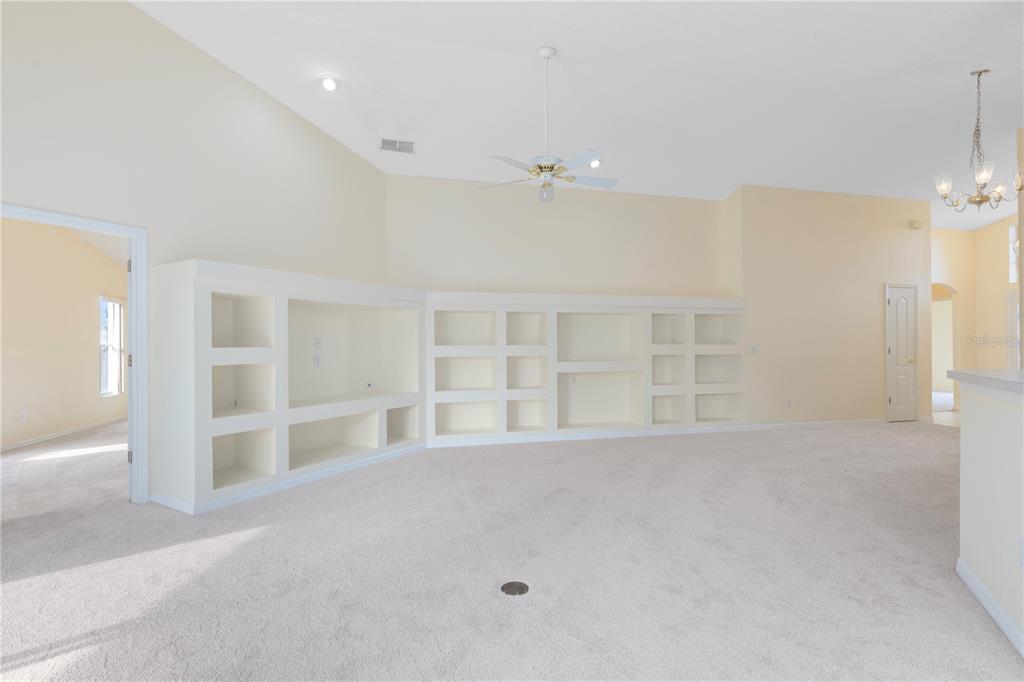 3640 Sickle Street Orlando, FL 32812 - Photo 8 of 21 an empty room with windows and pillars in it