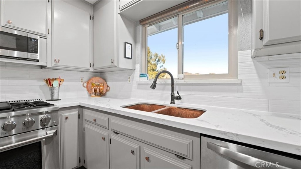 32 Mission Olive Road Oroville, CA 95966 - Photo 12 of 52 a kitchen with stainless steel appliances granite countertop a sink a stove and cabinets