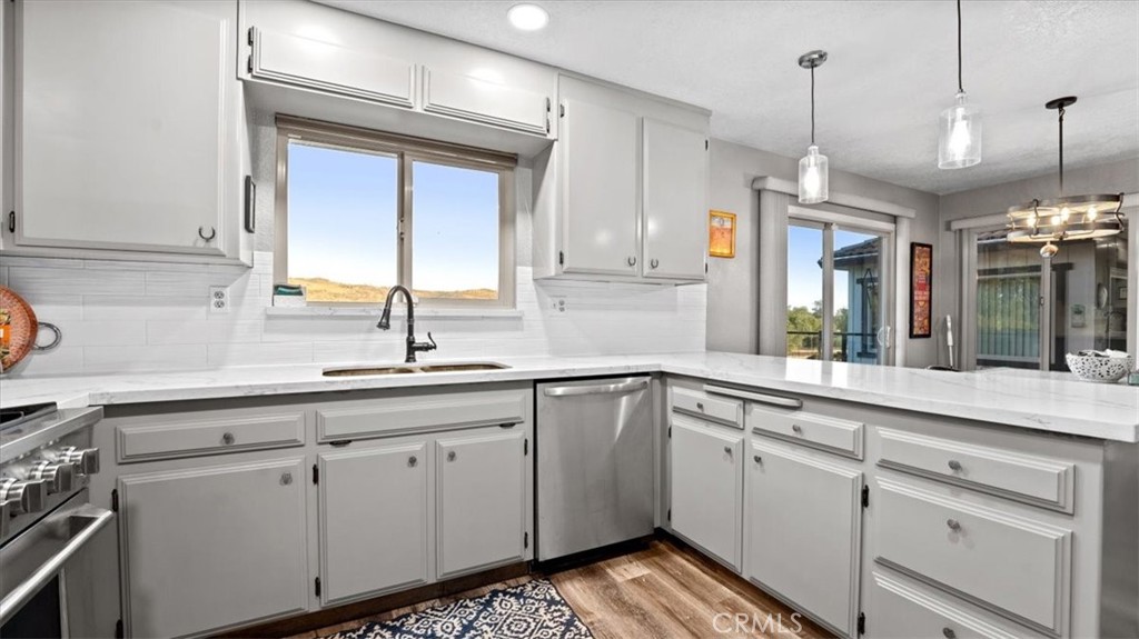 32 Mission Olive Road Oroville, CA 95966 - Photo 13 of 52 a kitchen with a sink stove and cabinets