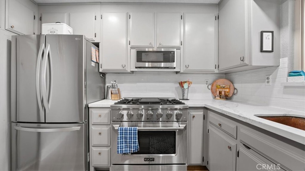 32 Mission Olive Road Oroville, CA 95966 - Photo 14 of 52 a kitchen with stainless steel appliances a stove a refrigerator and a sink