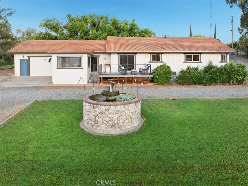 32 Mission Olive Road Oroville, CA 95966 - Photo 4 of 52 a front view of a house with a garden