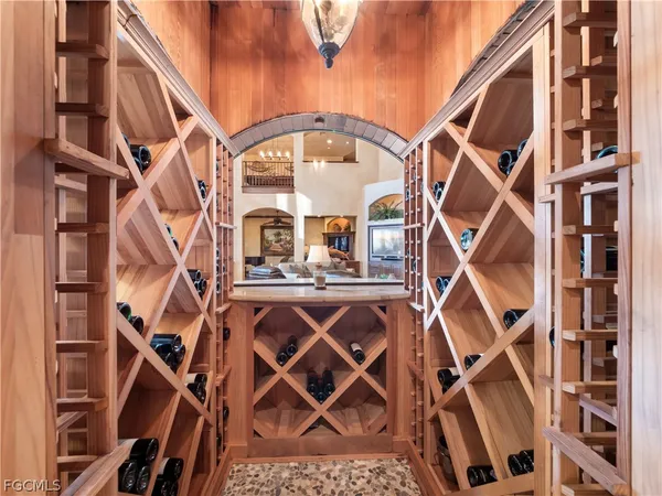 a dining room with furniture a chandelier and wooden floor