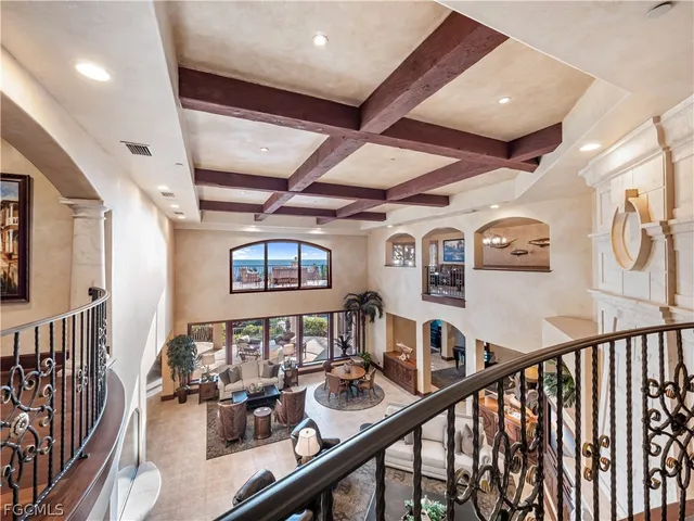 a view of staircase with lots of frames on wall and wooden floor