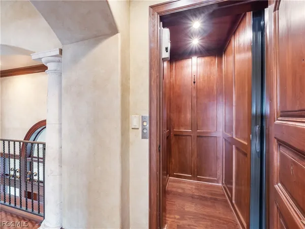 a spacious bedroom with a balcony a bed a fireplace and a potted plant