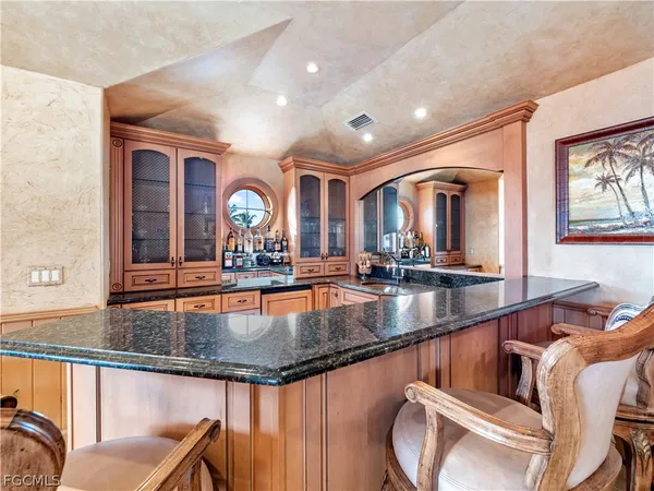 a spacious bedroom with a bed a couch and a window