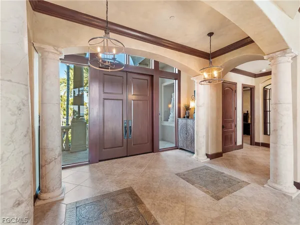 a view of a hallway with entryway a chandelier and livingroom