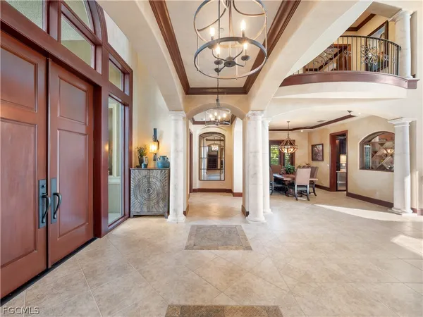 a living room with furniture kitchen view and a large window