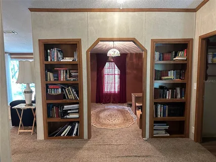 a view of an empty room with furniture and a fireplace