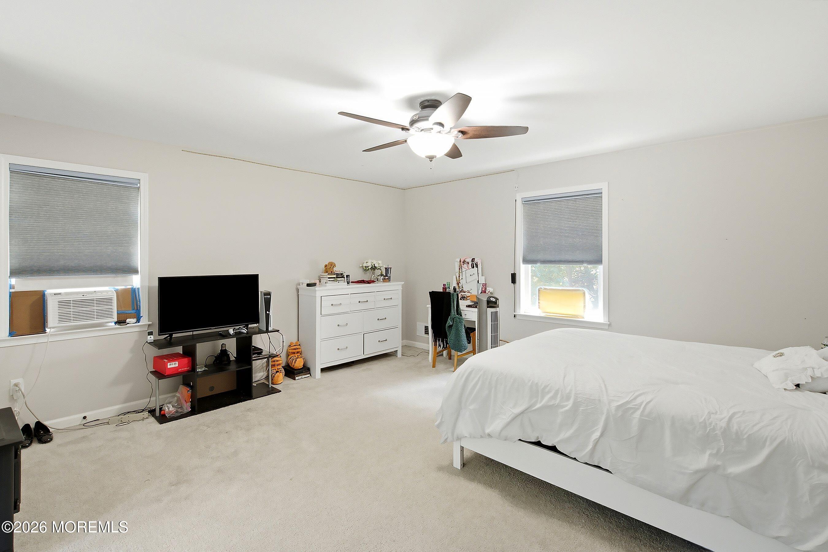 935 Bethel Church Road Jackson, NJ 08527 - Photo 17 of 32 a bedroom with a bed and a flat tv screen on dresser