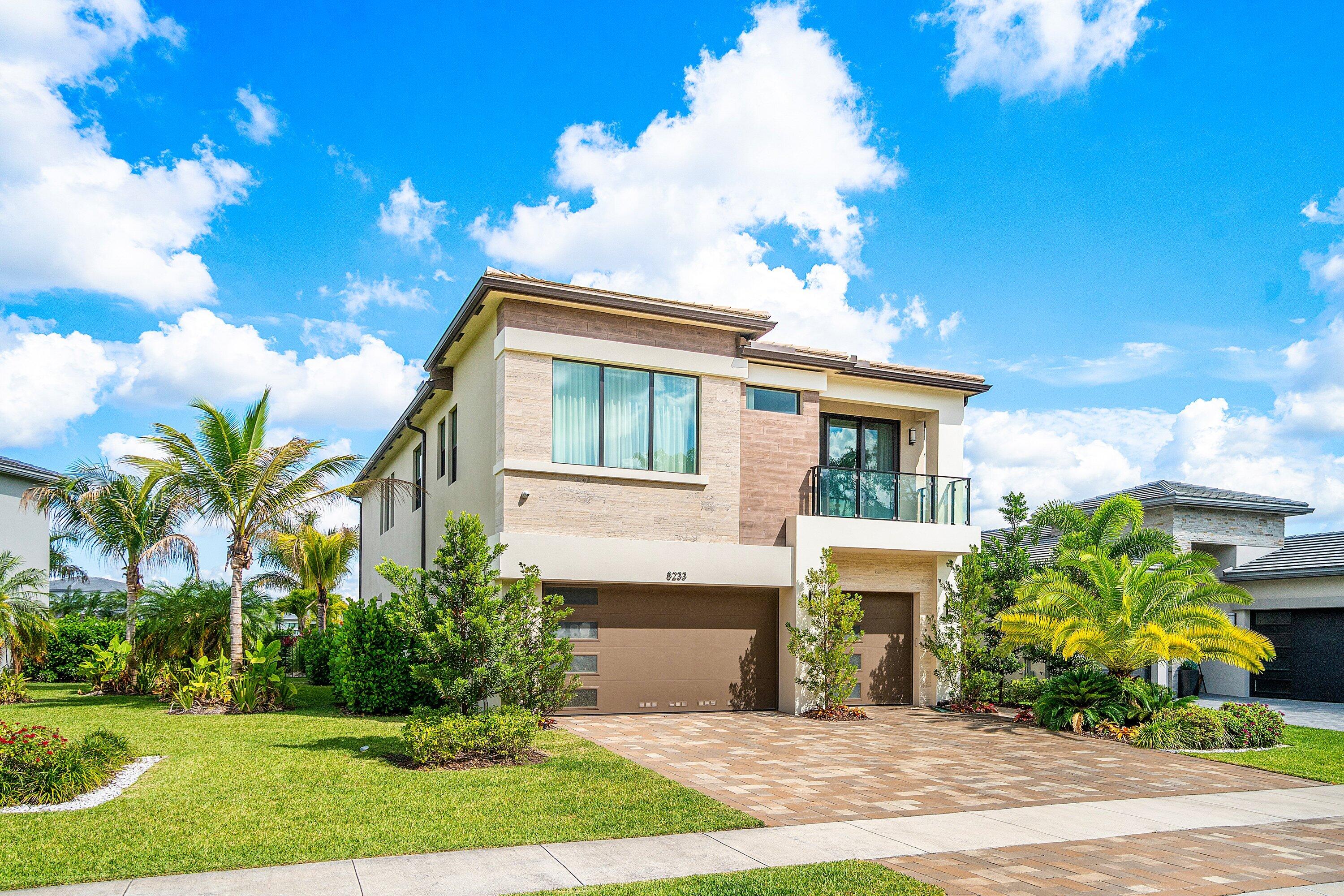 8233 Crystal Downs Avenue Boca Raton, FL 33434 - Photo 3 of 58 a front view of a house with a yard