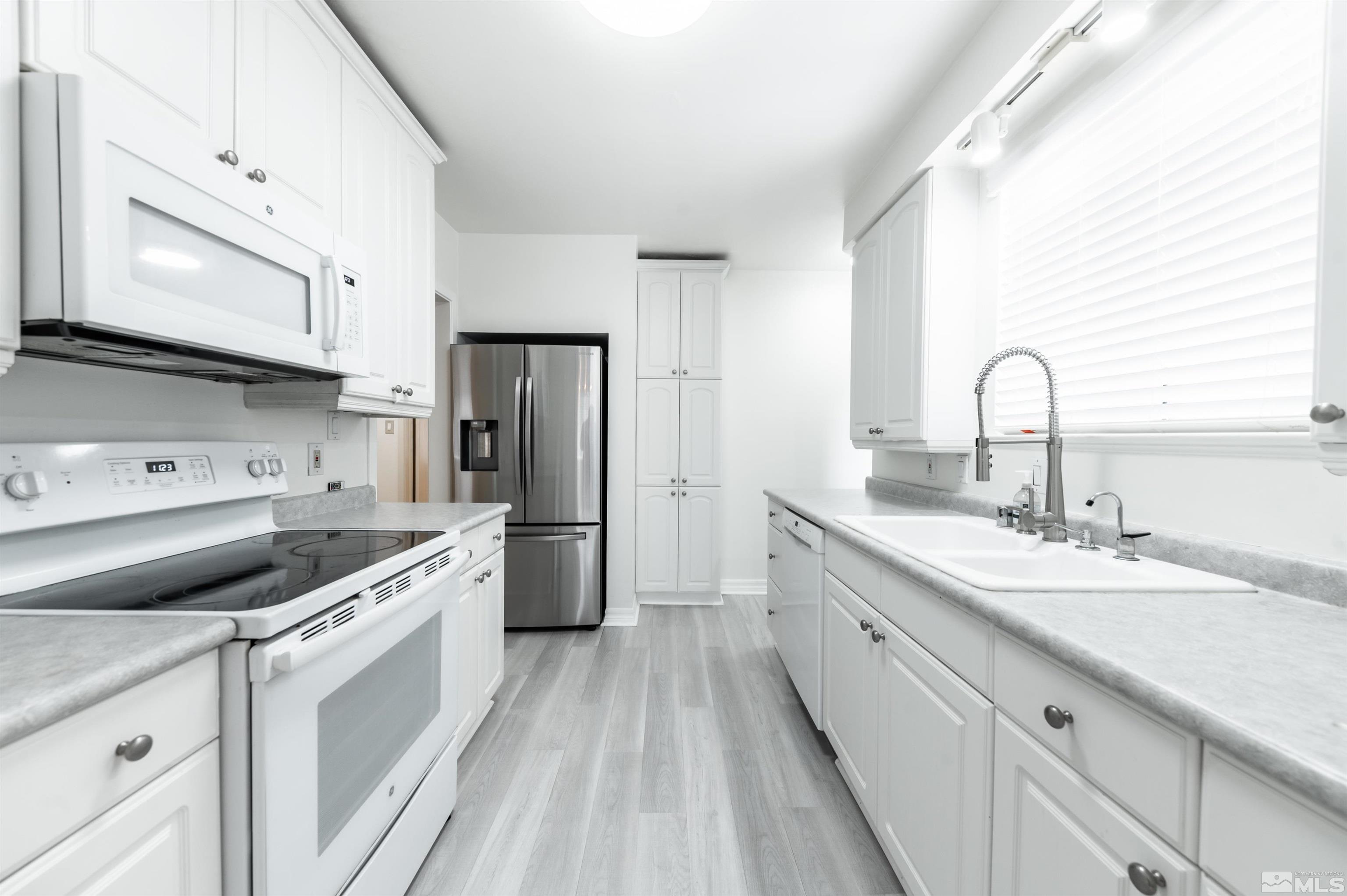 17 Linwood Place Reno, NV 89509 - Photo 15 of 36 a kitchen with a sink cabinets stainless steel appliances and a window