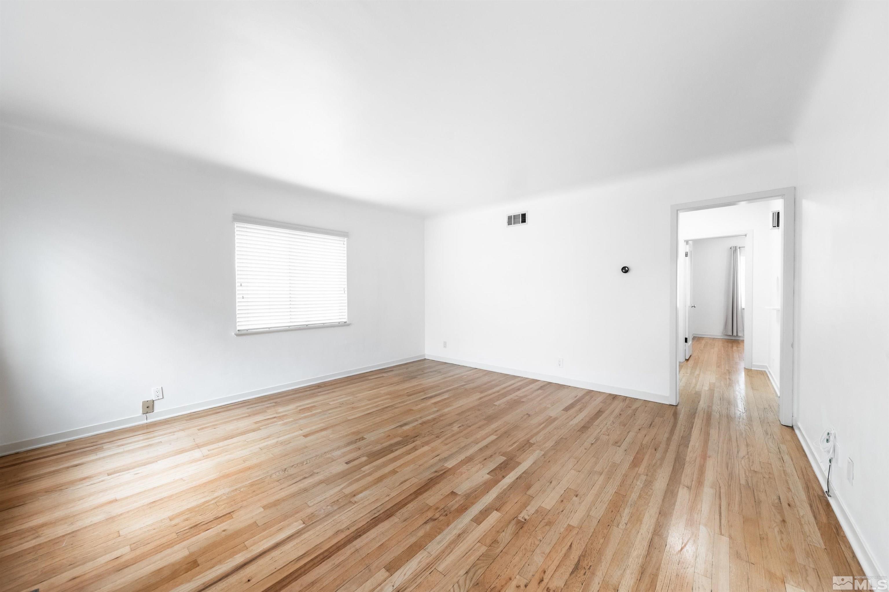 17 Linwood Place Reno, NV 89509 - Photo 8 of 36 an empty room with wooden floor and windows