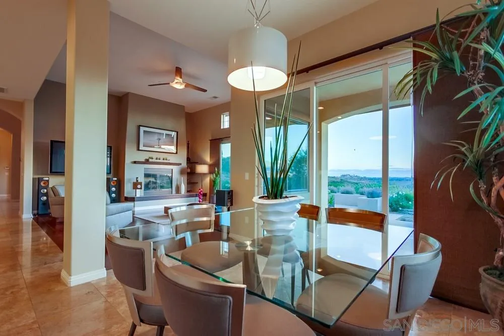 8248 Fortuna Santa Fe Road San Diego, CA 92127 - Photo 16 of 24 a dining room with furniture a chandelier and wooden floor