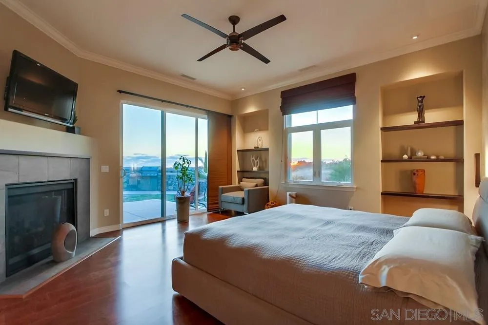 8248 Fortuna Santa Fe Road San Diego, CA 92127 - Photo 19 of 24 a bedroom with a bed and a flat screen tv
