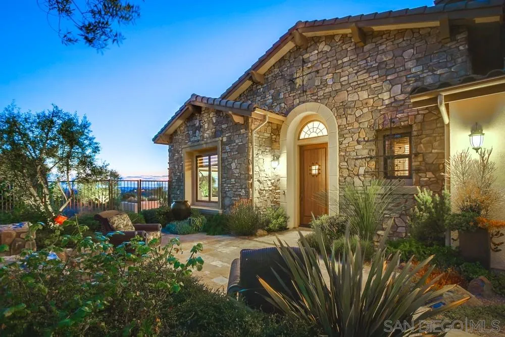 8248 Fortuna Santa Fe Road San Diego, CA 92127 - Photo 2 of 24 a front view of a house with a yard