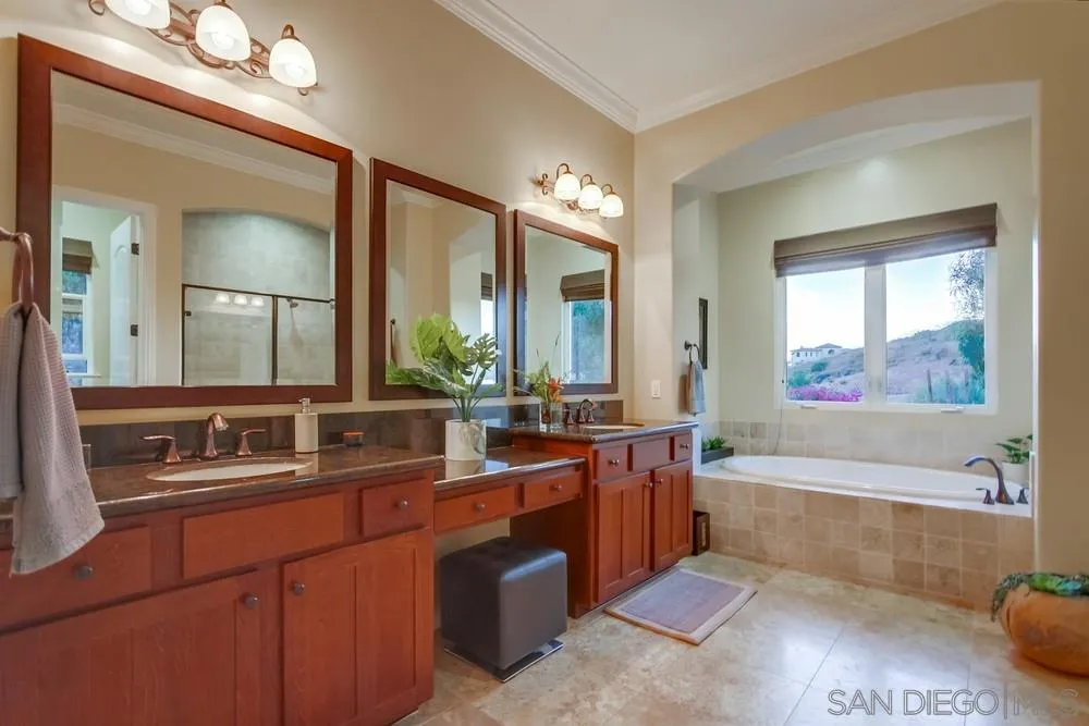 8248 Fortuna Santa Fe Road San Diego, CA 92127 - Photo 21 of 24 a bathroom with a tub a sink and mirror