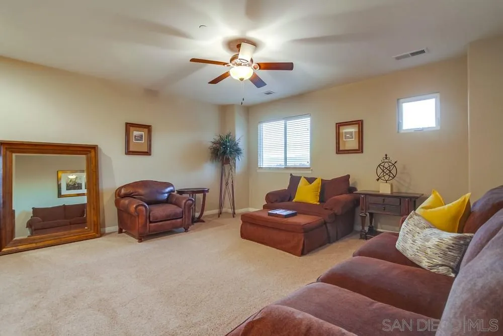 8248 Fortuna Santa Fe Road San Diego, CA 92127 - Photo 23 of 24 a living room with furniture and a ceiling fan