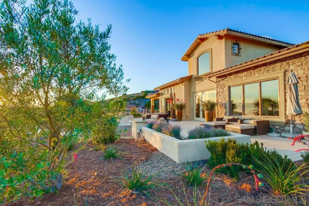 8248 Fortuna Santa Fe Road San Diego, CA 92127 - Photo 5 of 24 a view of a patio with couches table and chairs and potted plants