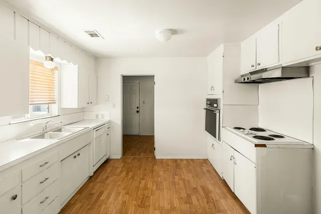 a kitchen with cabinets and appliances