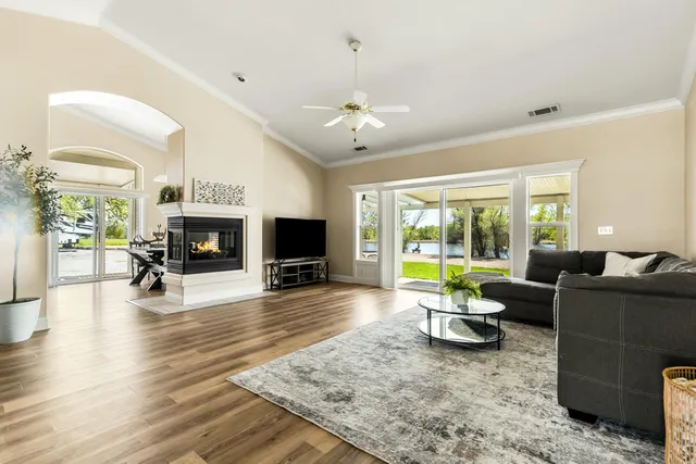 a living room with furniture a fireplace and a flat screen tv