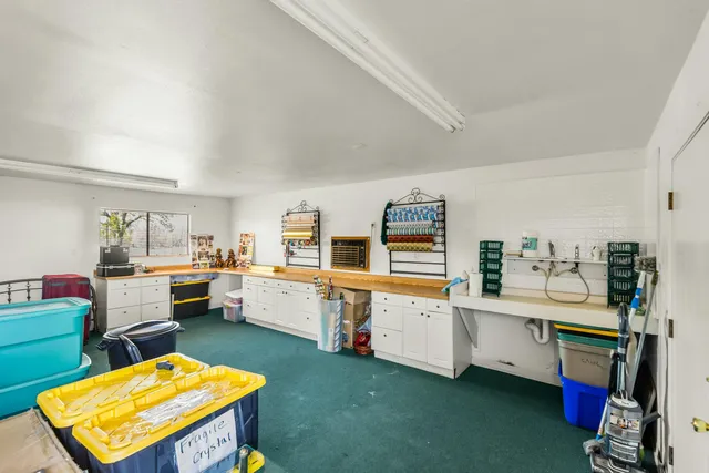 a room with furniture a rug and gym equipment