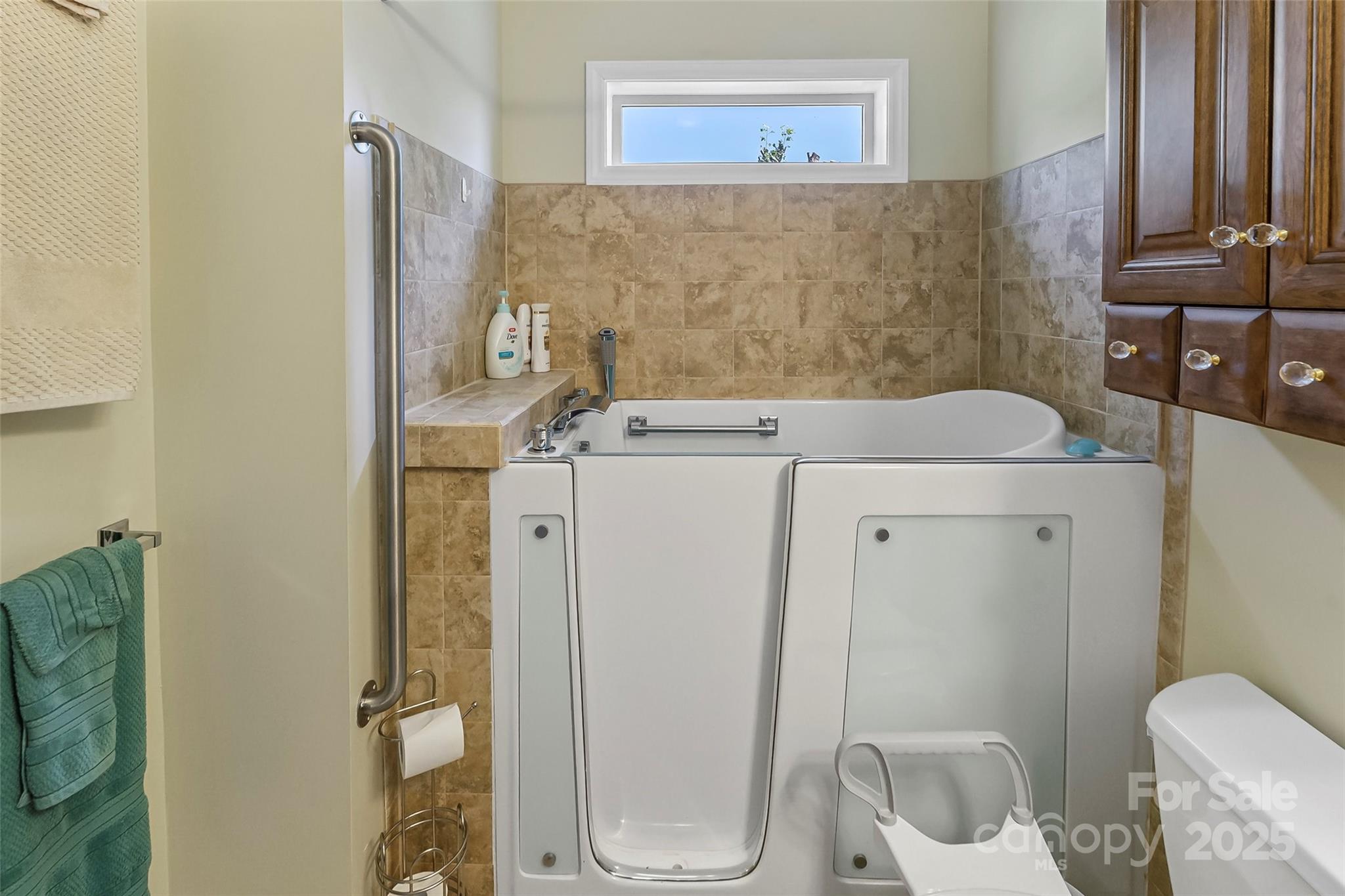 862 Asbury Road Candler, NC 28715 - Photo 11 of 18 a bathroom with a granite countertop toilet and a sink