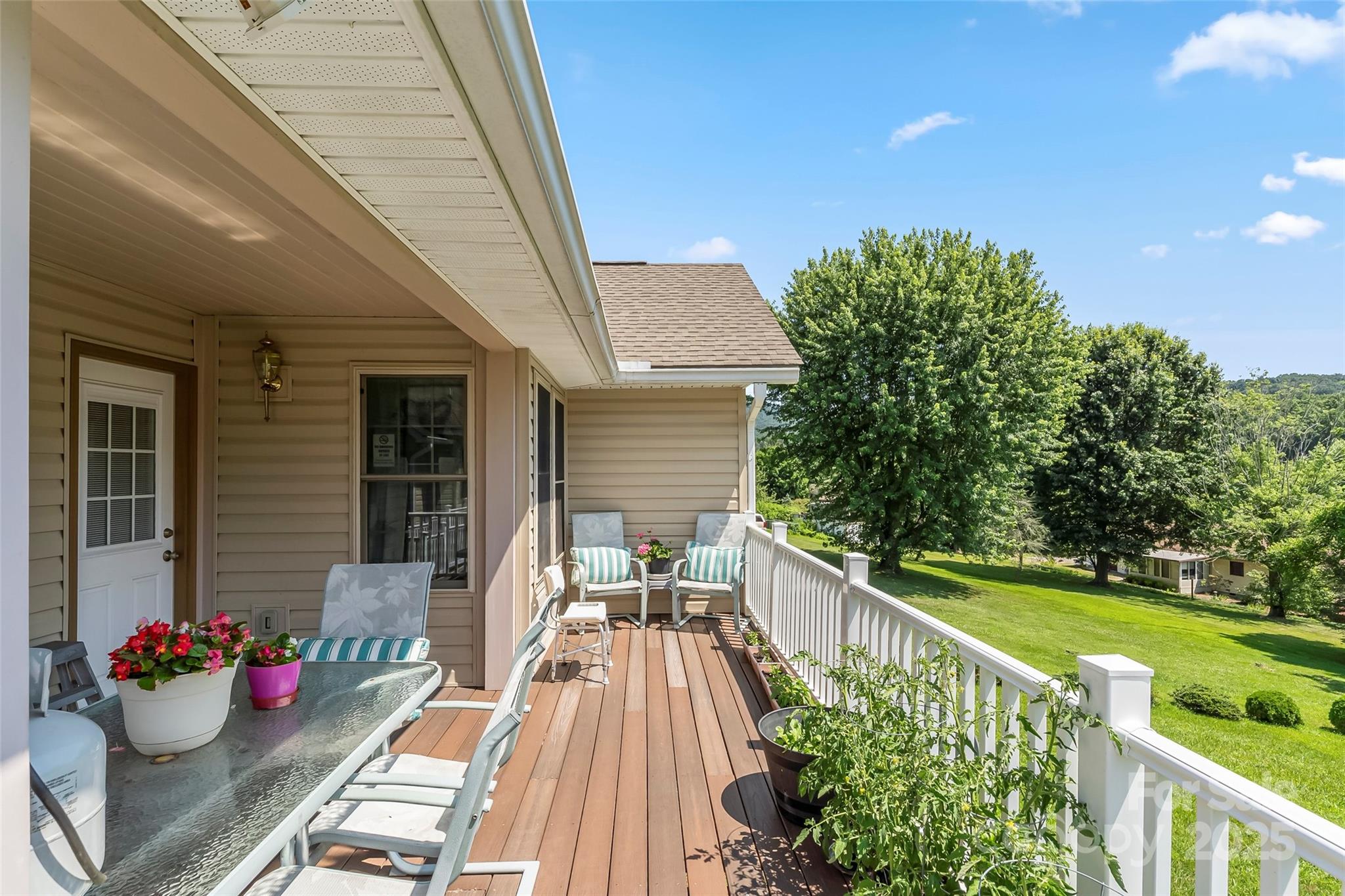 862 Asbury Road Candler, NC 28715 - Photo 15 of 18 a view of a two chairs and table in patio with a backyard