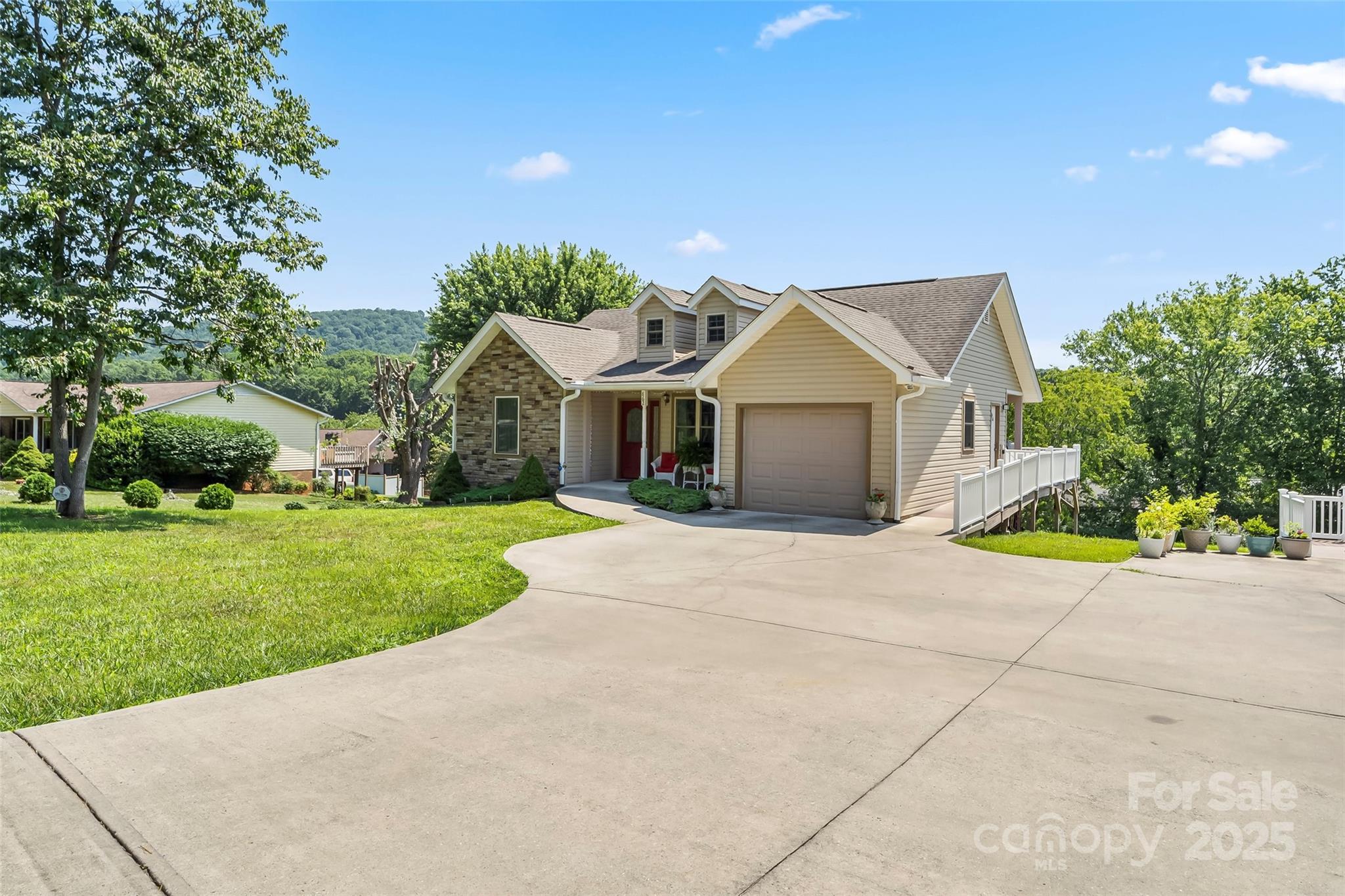 862 Asbury Road Candler, NC 28715 - Photo 17 of 18 a view of a house with a yard and potted plants