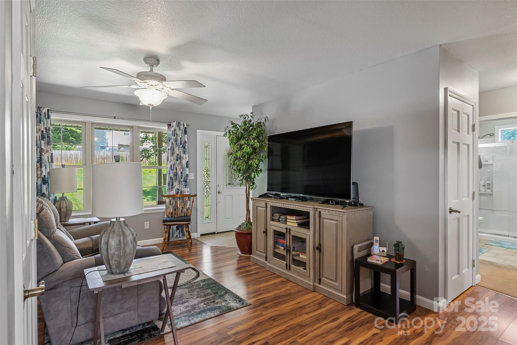 862 Asbury Road Candler, NC 28715 - Photo 2 of 18 a living room with furniture and a flat screen tv