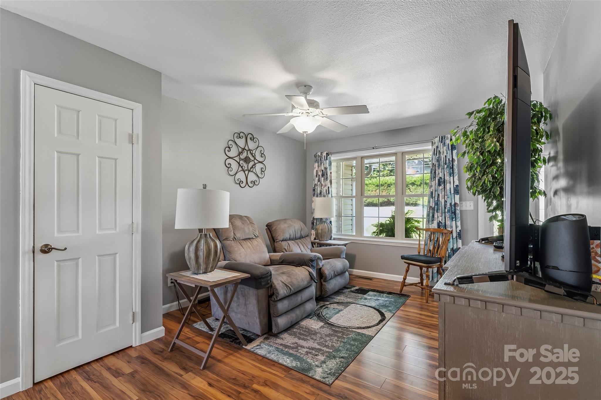862 Asbury Road Candler, NC 28715 - Photo 3 of 18 a living room with furniture a window and a flat screen tv