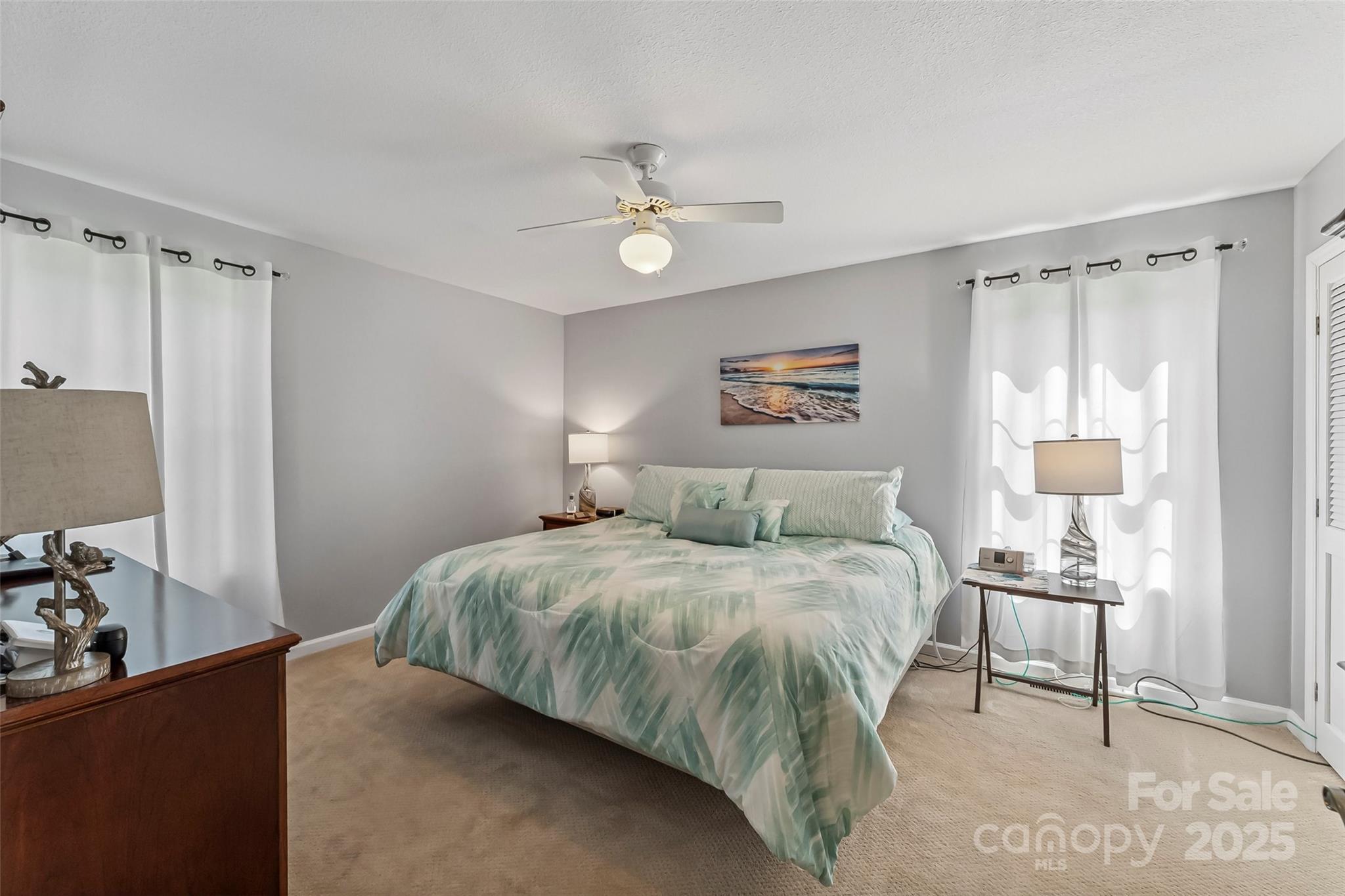 862 Asbury Road Candler, NC 28715 - Photo 7 of 18 a bedroom with a bed and a lamp on the dresser