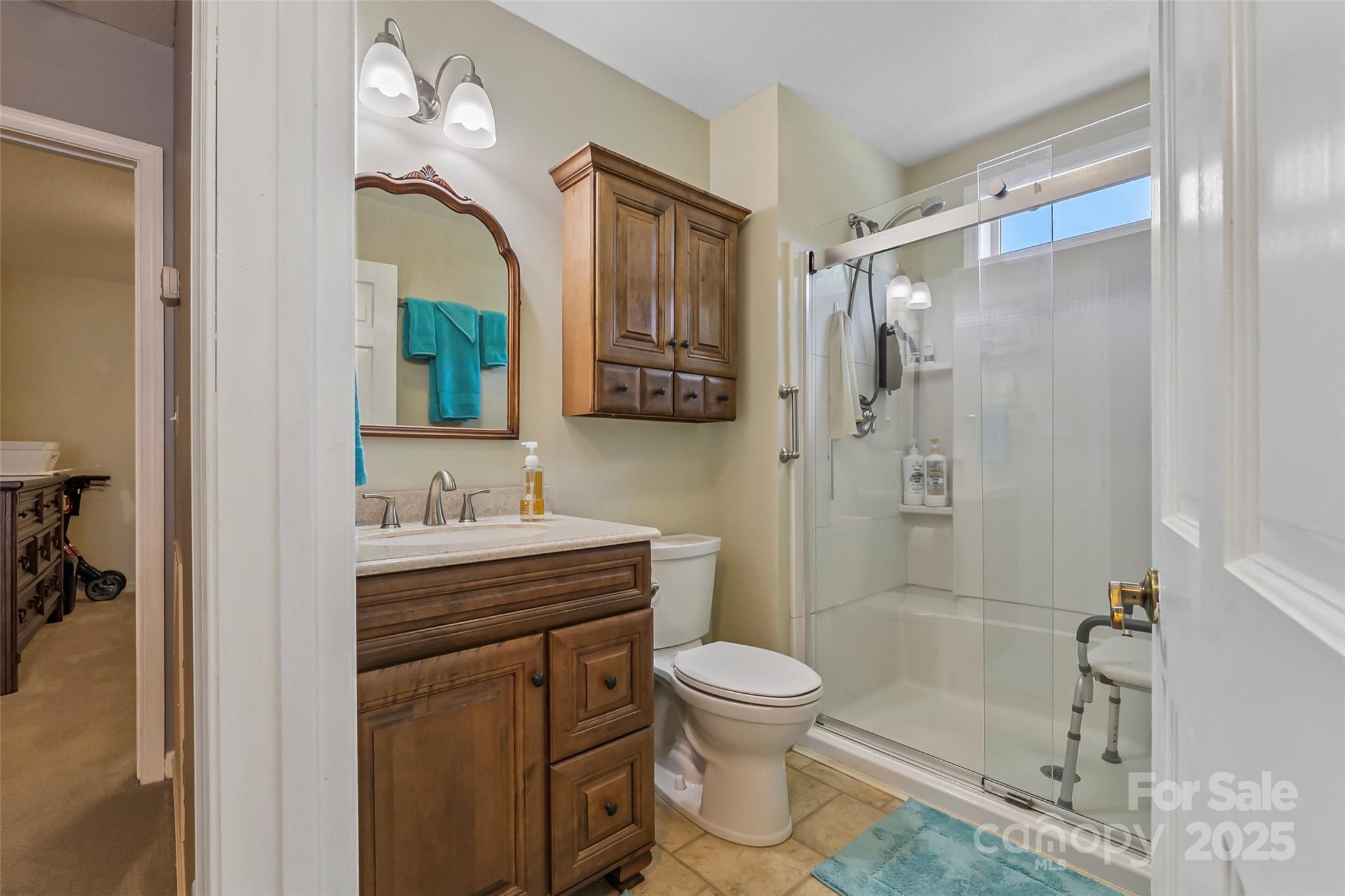 862 Asbury Road Candler, NC 28715 - Photo 8 of 18 a bathroom with a toilet a sink and shower