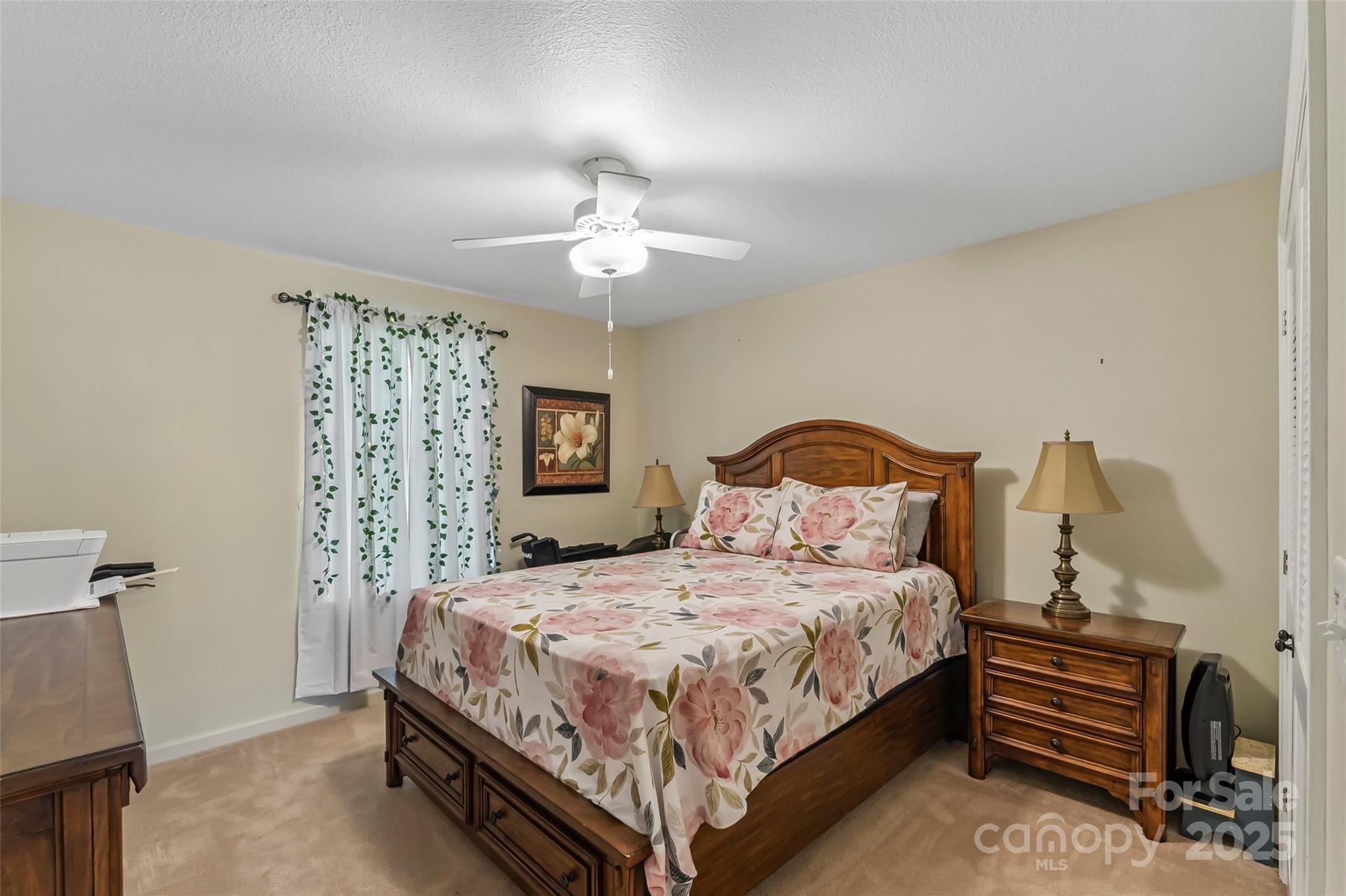 862 Asbury Road Candler, NC 28715 - Photo 9 of 18 a bedroom with a bed chandelier and a window
