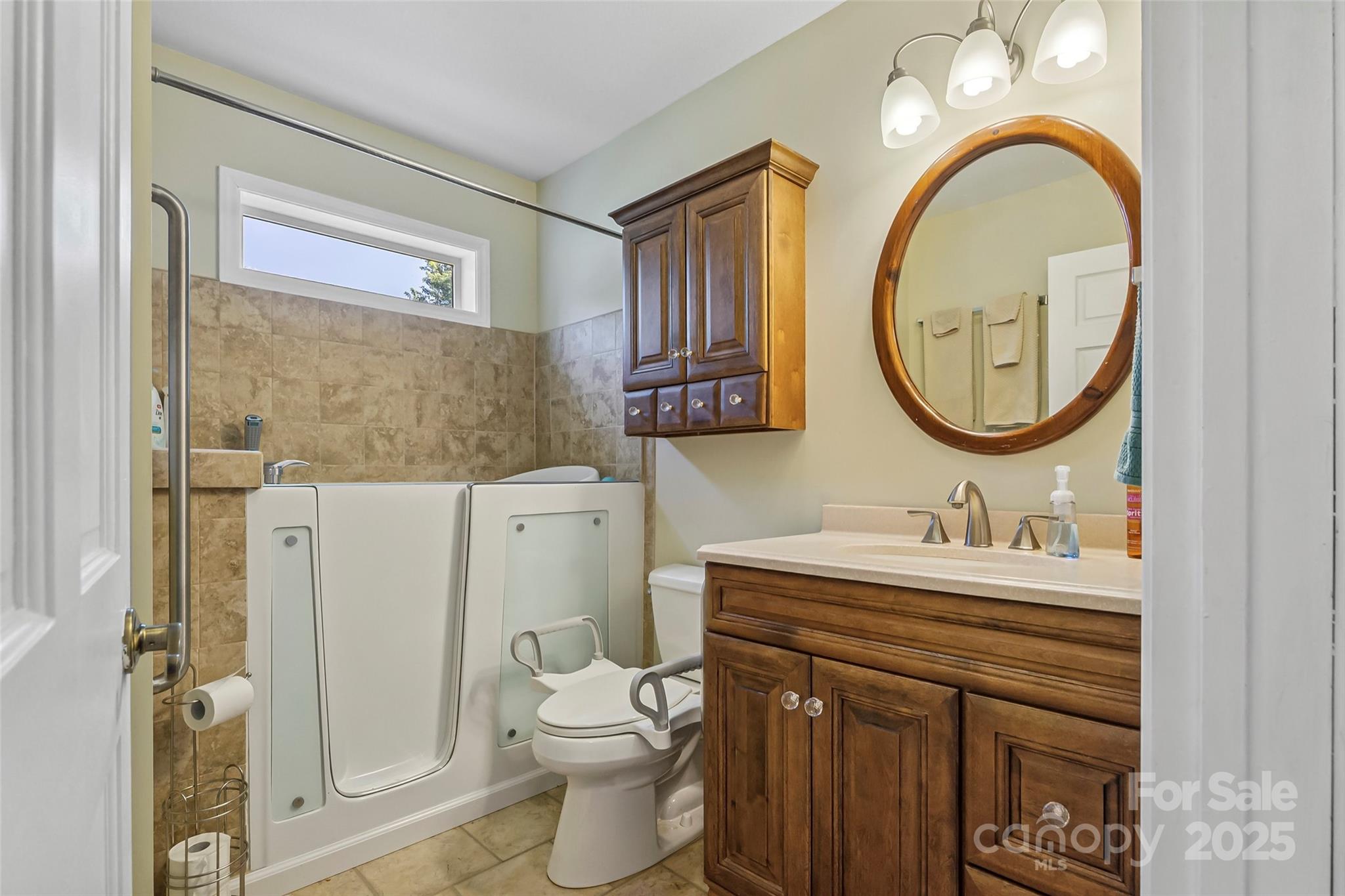 862 Asbury Road Candler, NC 28715 - Photo 10 of 18 a bathroom with a sink a toilet and a mirror