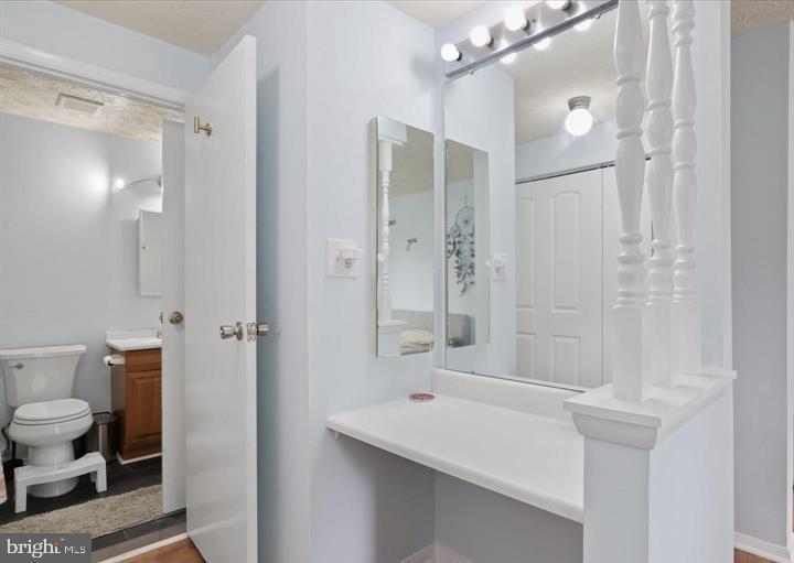 1654 Devil Lane Woodbridge, VA 22192 - Photo 12 of 21 a bathroom with a sink a toilet and shower