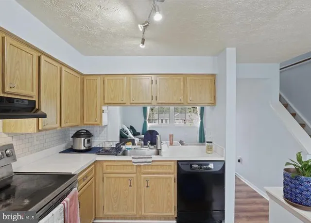 a kitchen with a sink stove and cabinets