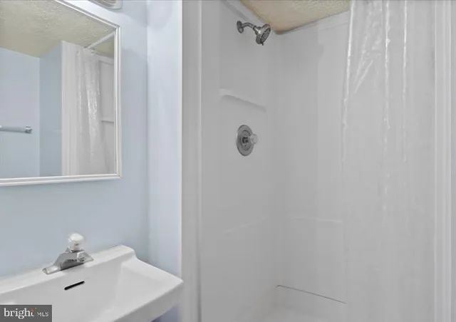 a bathroom with a sink and shower