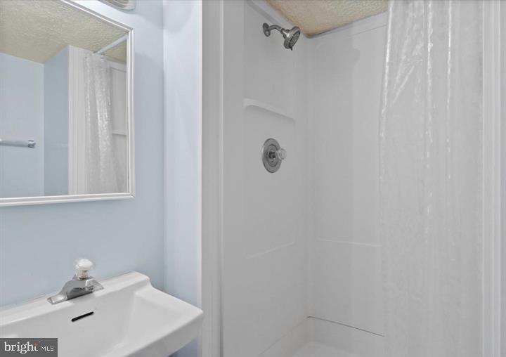 1654 Devil Lane Woodbridge, VA 22192 - Photo 8 of 21 a bathroom with a sink and shower