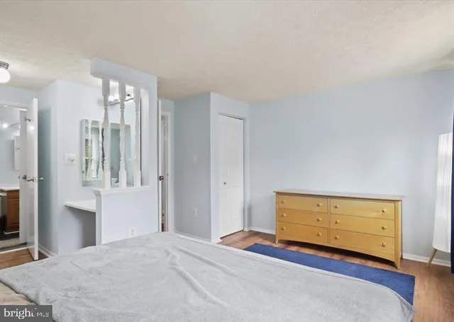 a view of a room with wooden floor and cabinet
