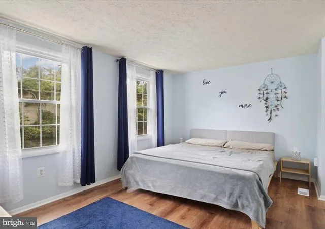 a bedroom with a large bed and a window
