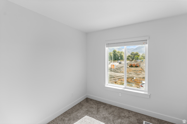 2995 South 265th Street West, Unit 752 Logan, UT 84321 - Photo 12 of 21 Room featuring neutral-toned carpeting, white baseboards, and a window with white trim