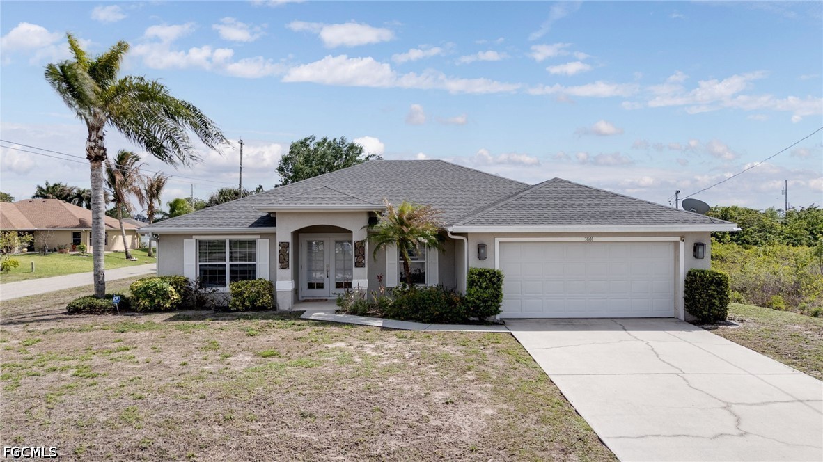 3801 28th Street Southwest Lehigh Acres, FL 33976 - Photo 1 of 37 a front view of a house with garden