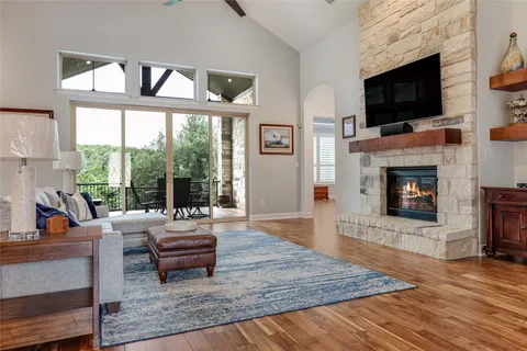 a living room with furniture a flat screen tv and a fireplace