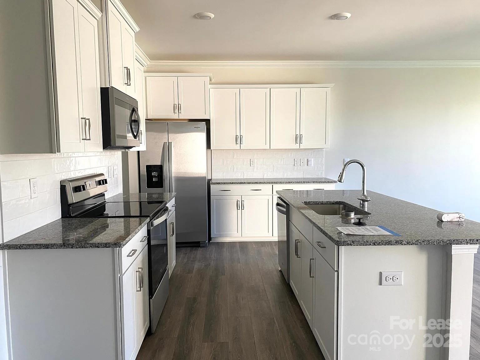 a kitchen with a sink stove and refrigerator