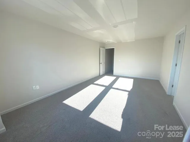 a bedroom with a bed and a mirror